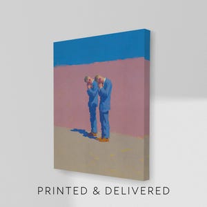 May include: A canvas print featuring an abstract painting with two figures in blue suits. The figures are positioned against a pink wall, with a blue sky above. The text "PRINTED & DELIVERED" is at the bottom.
