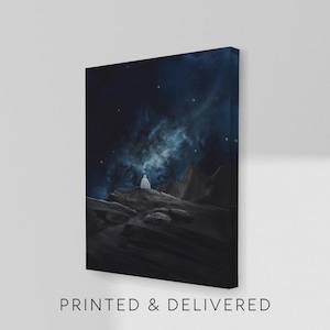 May include: Canvas art print depicting a figure in white robes seated on a rocky landscape under a starry night sky. The artwork features a dark blue and black color palette with a nebula-like formation in the background. Text at the bottom reads "PRINTED & DELIVERED."