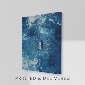 May include: A canvas print depicting a boat surrounded by a school of fish in a swirling pattern within deep blue ocean waters. The text "PRINTED & DELIVERED" is printed at the bottom of the canvas.