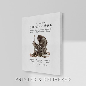 May include: A white canvas print featuring the text "PUT ON THE FULL ARMOR OF GOD" and a kneeling figure in armor holding a sword. The print includes the text "PRINTED & DELIVERED" at the bottom and Bible verse Ephesians 6:10-20.