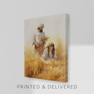 May include: Canvas art print depicting two figures in a wheat field. One figure, wearing a head covering, holds wheat. The other figure is seated, also among the wheat. The text "PRINTED & DELIVERED" is at the bottom.