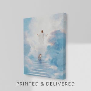 May include: A canvas print depicts a celestial scene with a figure in white robes at the top of a staircase, arms outstretched, and a dog ascending the stairs. The background features fluffy clouds in shades of blue and white. The text "PRINTED & DELIVERED" is at the bottom.