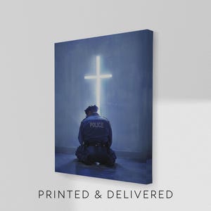 May include: A canvas print featuring a police officer kneeling before a glowing cross. The officer is wearing a dark blue uniform with the word "POLICE" on the back. The text "PRINTED & DELIVERED" is at the bottom.