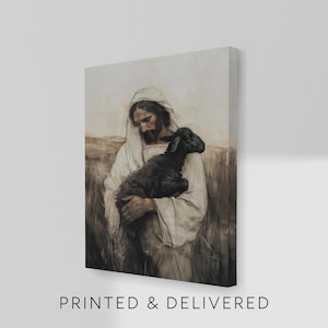 May include: A canvas print depicts a figure in white robes cradling a black lamb. The artwork has a sepia-toned color palette, with the text "PRINTED & DELIVERED" at the bottom. The image is mounted on a white wall.