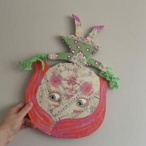 Girl standing on her head from papier mache