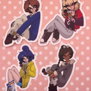 May include: Four stickers featuring anime-style characters in various outfits, each holding flowers. The characters are in different poses and wear a blue jacket, red jacket, yellow hoodie, and gray dress. The background is pink with white polka dots.