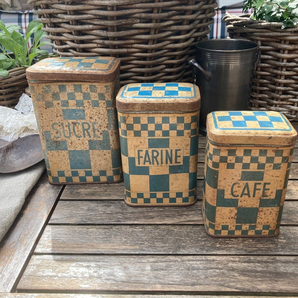 Latas antiguas francesas con estampado de cuadros Lustucru. Alrededor de 1920-1930