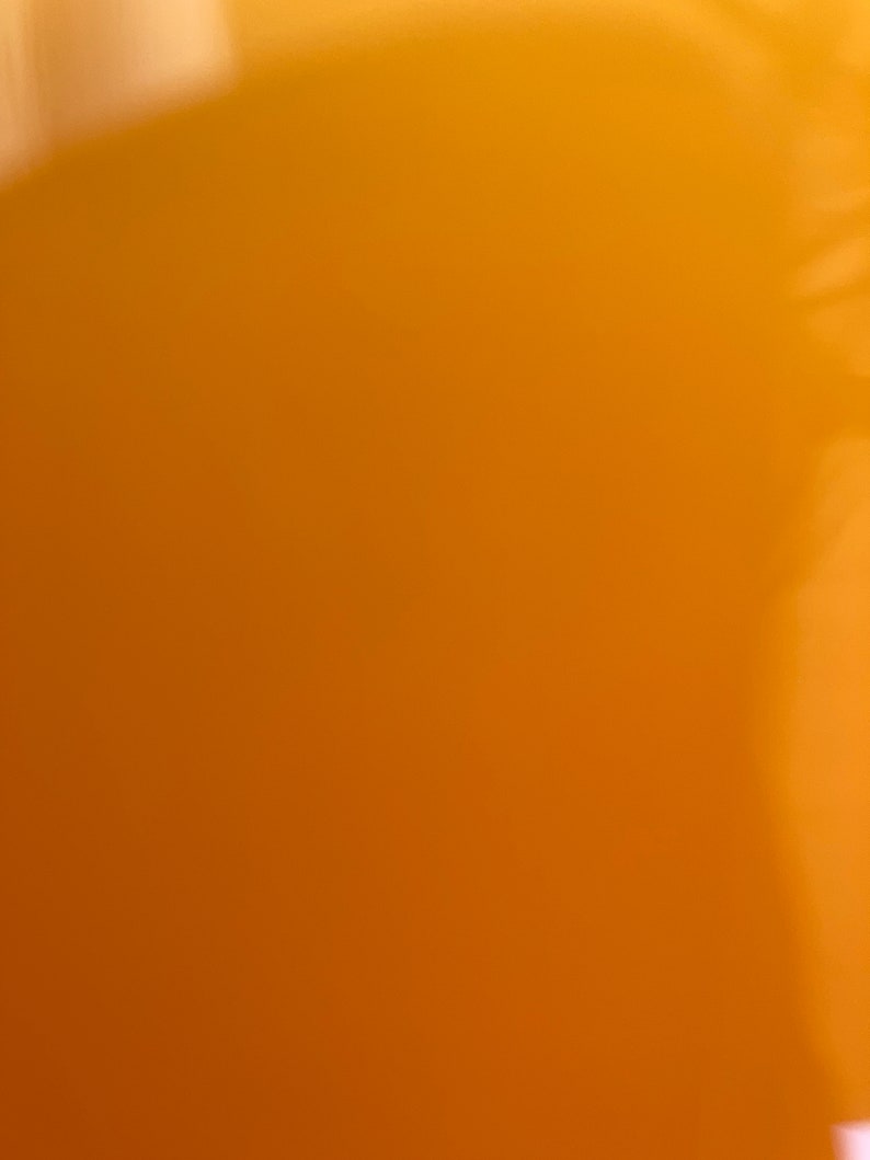 May include: A solid orange background with a slight gradient from light to dark.