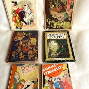 Op de afbeelding: Zes vintage kinderboeken met harde kaft en geïllustreerde covers. De titels zijn De bonte droom van het Circus, Goudhaartje en de Beertjes, Vader leest voor, Puss in Boots, Om stil te luisteren en Zonnestraaltjes, voorzien van kleurrijke illustraties.