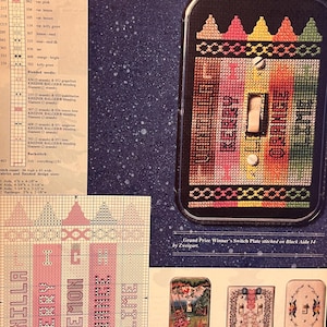 Könnte beinhalten: Ein farbenfrohes Kreuzstichmuster einer Lichtschalterplatte mit einem Regenbogen an Farben. Das Muster ist auf schwarzem Aida 14 Stoff gestickt. Der Text "Grand Prize Winner's Switch Plate stitched on Black Aida 14 by Zweigart." ist unter dem Muster gedruckt.