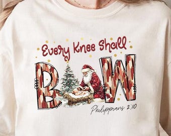 PNG «Toda rodilla se doblará», PNG «Santa Jesús arrodillado», PNG «Navidad cristiana», PNG «Fe Filipenses 2:10», PNG «Camiseta navideña religiosa»