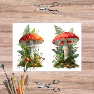 May include: Watercolor illustration of two red and white spotted mushrooms surrounded by ferns and greenery. The image includes a pair of scissors and a collection of paintbrushes in a ceramic cup, all set against a wooden background.