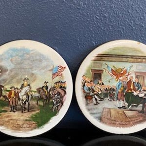 May include: A set of three ceramic vases in varying heights and shapes. The vases are glazed in a matte white finish, offering a minimalist aesthetic. The tallest vase is approximately 10 inches high.