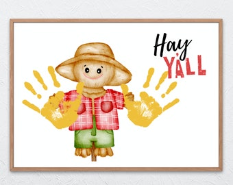 May include: A printable handprint art design featuring a cartoon scarecrow with a red and black plaid shirt and the text "Hay Y'all".