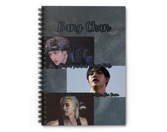 May include: Spiral-bound notebook with a dark gray cover featuring the text "Bang Chan" in a handwritten style. The notebook includes three images of a person and the phrases "Imma protect Stray Kids" and "Do it for the squad Do it for the team."
