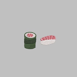 May include: An embroidered design featuring two pieces of sushi. One is a roll wrapped in green seaweed, and the other is a nigiri sushi with pink fish on top of white rice. The background is a solid gray.