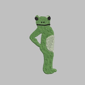 May include: Green embroidered frog standing with its arms crossed, looking to the right.