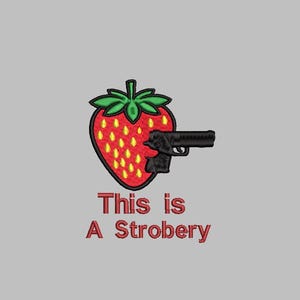 May include: Embroidered patch showing a red strawberry with a black handgun. The strawberry has green leaves and yellow seeds. The text "This is A Strobery" is in red below the image.