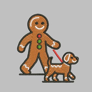 May include: Embroidered design of a gingerbread man walking a dog on a red leash. The gingerbread man has a smiling face and three button details. The dog is brown with white accents. The design is on a gray background.