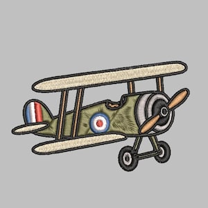 May include: An embroidered patch of a vintage biplane in olive green with a brown propeller, cream-colored wings, and black landing gear. The aircraft features a circular red, white, and blue roundel on the side and a French flag on the tail fin.