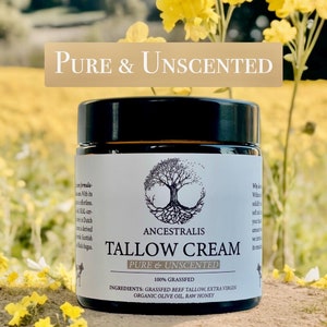 Peut inclure: Un pot en verre de cr&egrave;me de suif non parfum&eacute;e avec une &eacute;tiquette blanche qui indique "ANCESTRALIS TALLOW CREAM PURE & UNSCENTED 100% GRASSFED INGREDIENTS: GRASSFED BEEF TALLOW, EXTRA VIRGIN ORGANIC OLIVE OIL, RAW HONEY". Le pot est pos&eacute; sur une surface brune avec des fleurs jaunes.