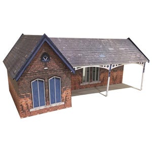 May include: A brick building with a slate roof and a covered porch. The building has two windows and a small decorative detail above the door.