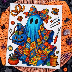 May include: A canvas print featuring a blue ghost wearing a large floral bow and a patchwork quilt cloak. The ghost holds a blue pumpkin basket filled with thread spools. Surrounding elements include sewing needles, buttons, and a tape measure.