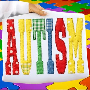 May include: A white sign with the word "AUTISM" in colorful, stitched letters. The letters are red with white polka dots, yellow with a gingham pattern, green with a plaid pattern, blue, red, and yellow with white polka dots. The background is a colorful jigsaw puzzle.