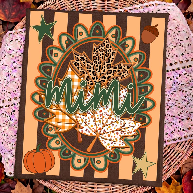 May include: A rectangular sign featuring vertical brown and light orange stripes with a central oval frame containing three maple leaves with leopard print, orange gingham, and white leaf patterns. The word Mimi is written in green script.