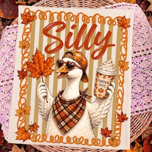 May include: A rectangular decorative sign featuring a white goose wearing a brown baseball cap, heart-shaped sunglasses, and a plaid bandana. The goose holds an orange maple leaf and a cup labeled Pumpkin Spice. The background has tan stripes.
