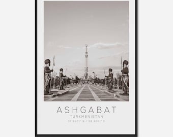 May include: A black and white photograph of a monument in Ashgabat, Turkmenistan. The monument is a tall, slender tower with a star on top. There are statues of soldiers on either side of the monument.