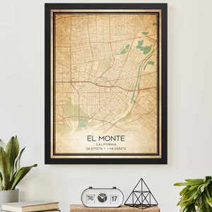 May include: A vintage-style map print of El Monte, California, with a black frame. The map shows the city's streets and landmarks in brown and green hues. The text "El Monte, California 34.0712°N / -118.0352°E" is printed at the bottom of the map.