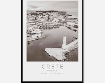 May include: A black and white aerial photograph of a town on the island of Crete, Greece. The photo shows a harbour with a lighthouse at the end of a pier. The text "CRETE GREECE 35.2401° N / 24.8093° E" is at the bottom of the image.