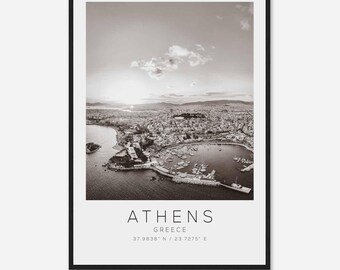 May include: A black and white aerial photograph of Athens, Greece. The photo shows the city's harbor and surrounding buildings. The text "ATHENS GREECE 37.9838° N / 23.7275° E" is printed below the image.