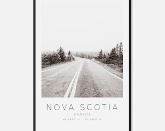May include: Black and white framed print featuring a winding road through a forested landscape. The print includes the text "NOVA SCOTIA" and "CANADA" along with the coordinates 44.6820° N / -63.7443° W.