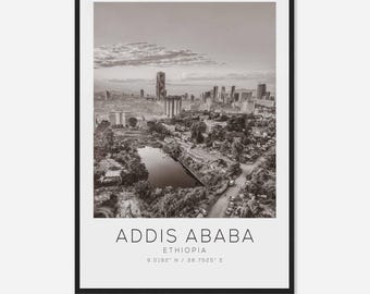 May include: A black and white aerial photograph of Addis Ababa, Ethiopia. The city is spread out with buildings and trees. A small lake is visible in the center of the image. The text "Addis Ababa, Ethiopia 9.0192° N / 38.7525° E" is at the bottom of the image.