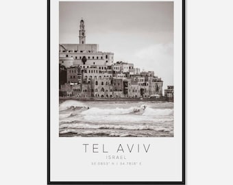 May include: A black and white photograph of Tel Aviv, Israel, with a cityscape in the background and waves crashing in the foreground. The text "Tel Aviv" and "Israel" are printed below the image, along with the coordinates "32.0853° N / 34.7818° E".