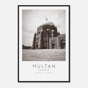 May include: Black and white photograph of a large, domed building in Multan, Pakistan. The image is framed in a black border and includes the city name and country. The building has a large dome and several smaller towers.