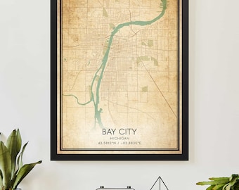 May include: A vintage-style map print of Bay City, Michigan. The map is in shades of brown and green, with a river winding through the city. The text "Bay City, Michigan 43.5813°N / -83.8835°E" is printed at the bottom of the map.