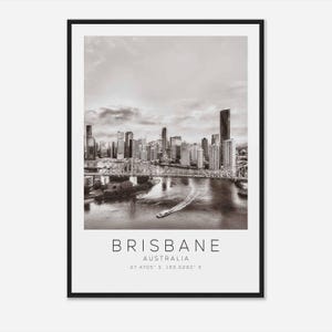 May include: A black and white photograph of the Brisbane skyline, featuring the Story Bridge and the city's skyscrapers. The text "BRISBANE AUSTRALIA 27.4705' S, 153.0260' E" is printed below the image.