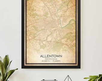 May include: A framed vintage-style map of Allentown, Pennsylvania. The map shows the city's layout, including streets and green spaces, on a sepia-toned background. The black frame surrounds the map, with the city name and coordinates displayed.