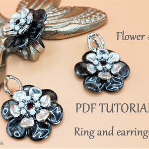 May include: A PDF tutorial for making a ring and earrings with black and silver flower designs. The flowers are made with beads and have a red center.