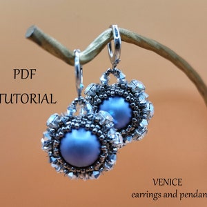 May include: A pair of silver earrings with a blue pearl center and crystal accents. The earrings are hanging from a branch. The text "PDF TUTORIAL" and "VENICE earrings and pendant" is visible in the image.