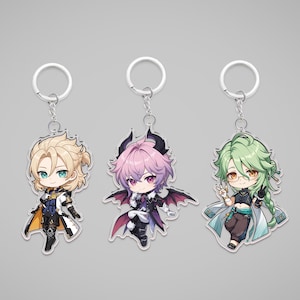 May include: Three anime-style character keychains. The keychains feature colorful illustrations of characters with unique outfits and hairstyles. Each keychain has a silver keyring attached.