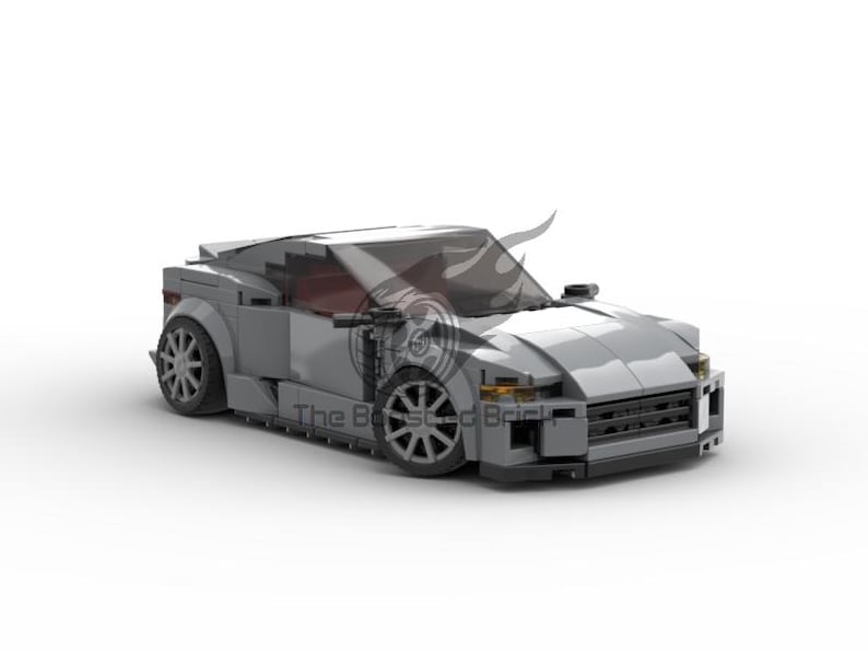 May include: A gray toy car with a sleek, modern design. The car features a low profile, detailed wheels, and a tinted windshield. The vehicle is set against a white background, highlighting its form and structure. The car is a model of a sports car.