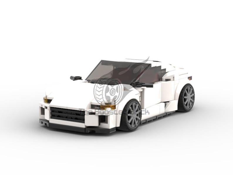 May include: A white sports car model constructed from interlocking toy bricks. The car features a sleek design with dark tinted windows and gray wheels. The front of the car has black detailing and headlights. The logo "The Boost Garage" is visible on the side.