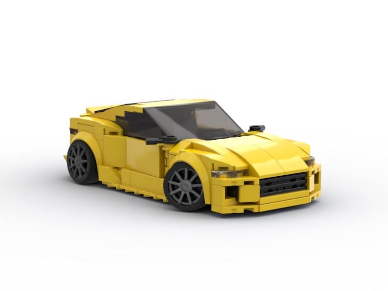 May include: A bright yellow toy sports car made of interlocking plastic bricks. The car has black wheels, a black windshield, and black side mirrors. The car's design is aerodynamic, with a low profile and sleek lines.