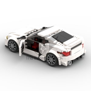 May include: A white toy sports car made of interlocking plastic bricks. The car has a sleek design with a black roof, red interior, and gray wheels. The driver's side door is open, revealing the interior. The car has a rear spoiler and dual exhaust pipes.