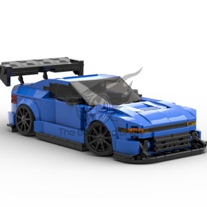 May include: A blue Lego race car with a black spoiler and black wheels. The car has a black front bumper and a black grille.