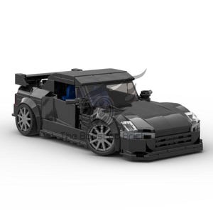 May include: A black Lego car model with a spoiler, large wheels, and a detailed front end.